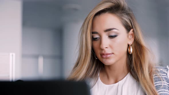 Happy Businesswoman Working on Her Laptop in the Office