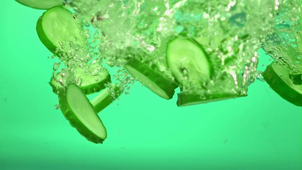 Super Slow Motion Pieces of Cucumber Under Water with Air Bubbles