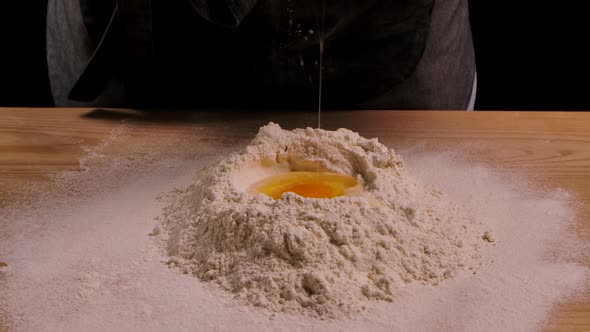 Slow Motion of Falling Egg Into Flour Pile