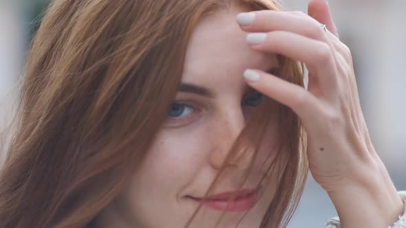 Portrait of Beautiful Redhaired Young Woman on Street in Slow Motion