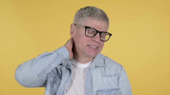 Casual Senior Man with Neck Pain, Yellow Background