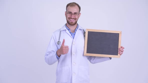 Happy Bearded Man Doctor Holding Blackboard and Giving Thumbs Up