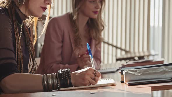 Female Gothic Student Taking Notes at Lesson