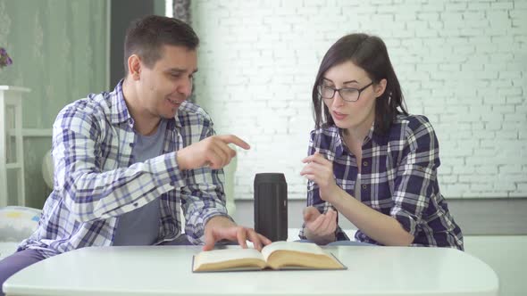 Man and Young Woman Married Couple Use Voice Assistant