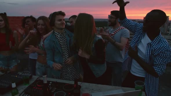 DJ Mixing Music for Friends on Rooftop