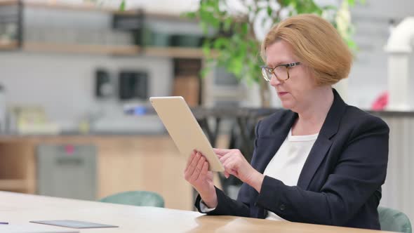 Excited Businesswoman Celebrating Success on Tablet