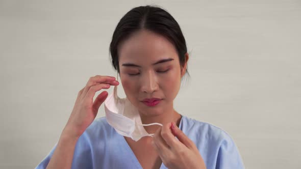Young Asian Woman Take Off Face Mask Removing From Face