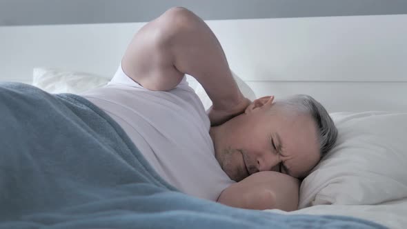 Tired Gray Hair Man with Neck Pain Sleeping in Bed