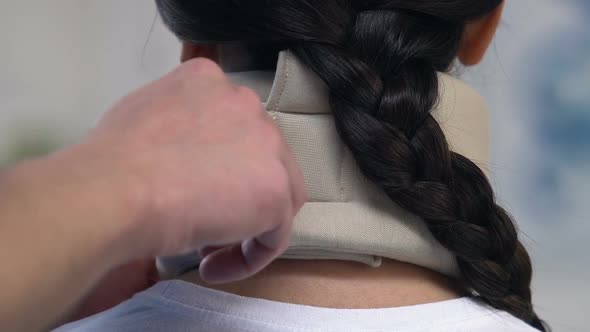 Traumatologist Applying Female Patient Foam Cervical Collar, Injury Treatment