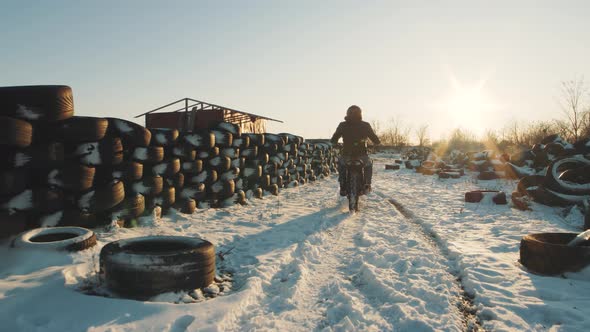 Biker Ride on Bike in the Snow Field Slow Motion