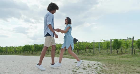 Romantic Couple Walking To Green Vineyards, Side Follow Wide shot, Friends Italian Trip in Umbria