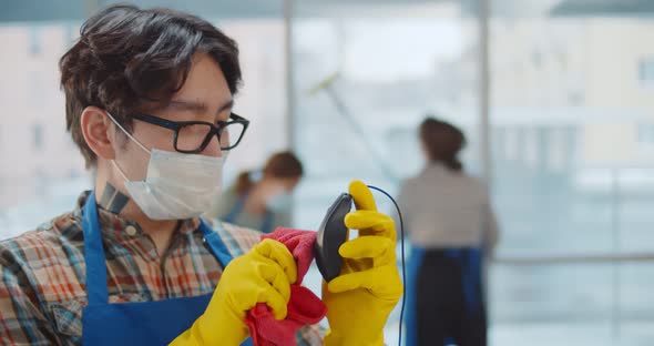 Close Up of Asian Janitor in Safety Mask Disinfecting Mouse with Cloth