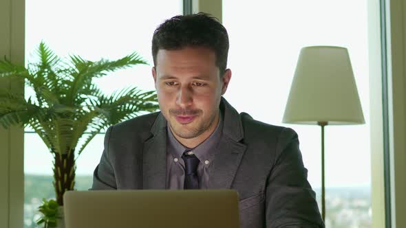 Young Handsome Businessman Working in Modern Office