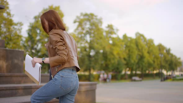 Creative Teenage Girl with Red Hair Sketching in City