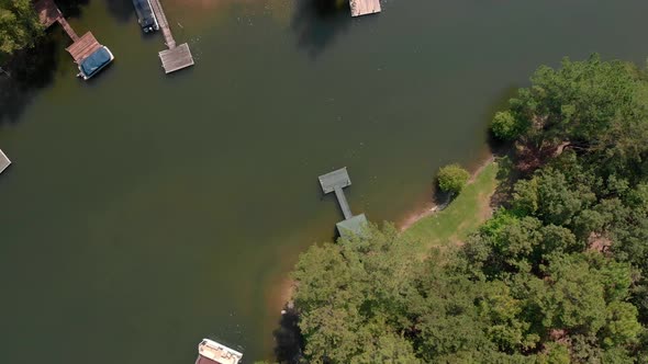 Slow aerial zoom in of dock on lake.