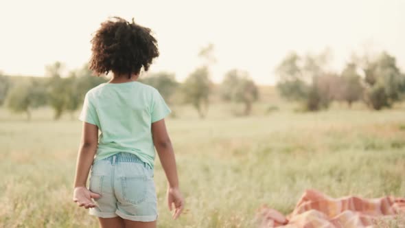 A back view of a small american girl is walking