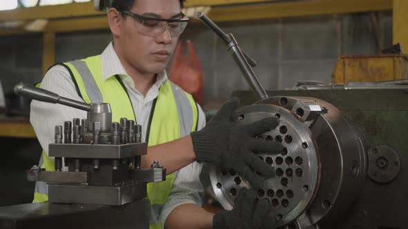 mechanical man wear uniform hardhat and goggles safety workers are tightening bolts