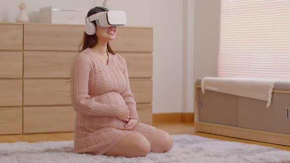 Pregnant woman using virtual reality glasses for practice tutorial to take care of a newborn baby