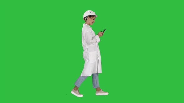 Female Scientist Using Smartphone Walking on a Green Screen