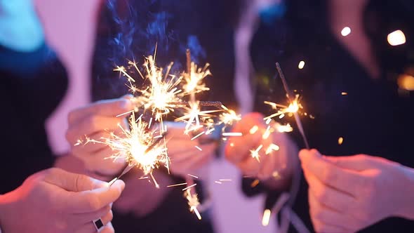 Group of Friends Having Fun with Sparklers. Night Party Concept