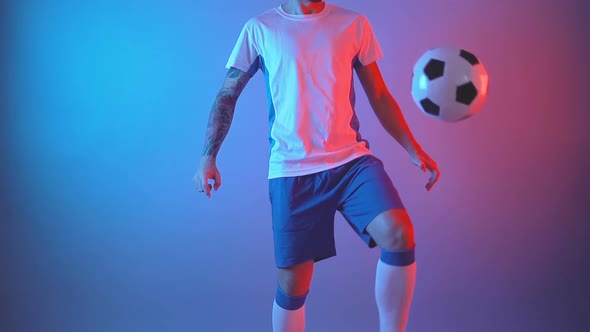 Professional Football Player Juggling Ball with His Legs and Knees