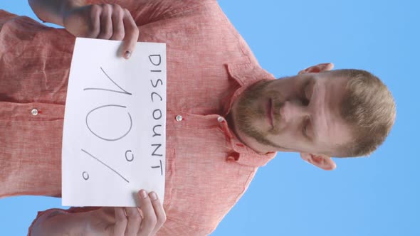 Young Man Holding Discount Sign