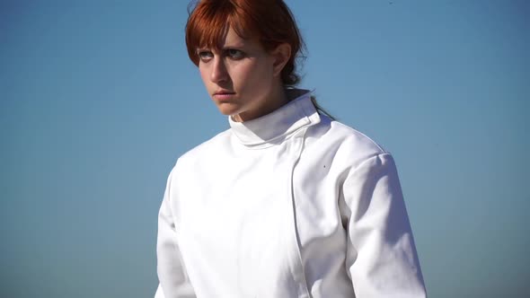 A man and woman fencing on the beach