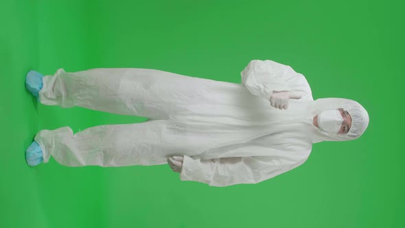 Asian Male Wear Protective Uniform PPE And Showing Thumbs Up In Green Screen Studio