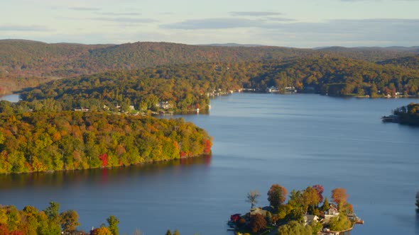 Aerial of beautiful lake surrounded with autumn forest