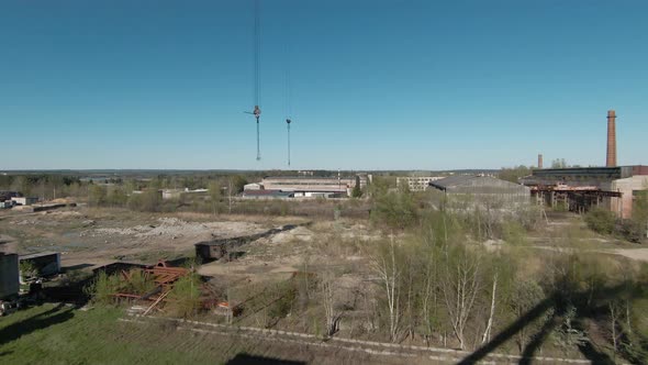 FPV Drone Flies Maneuverable Near Abandoned Walking Excavator