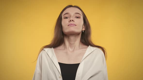 Woman Taking a Deep Breath and Exhale on a Bright Yellow Background