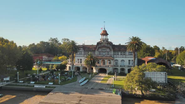 Aerial orbit of Tigre private rowing club near de la Plata river surrounded by vegetation at golden