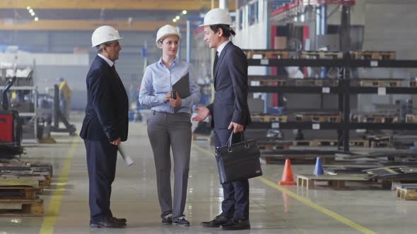 Engineer Meeting with Colleagues at Factory