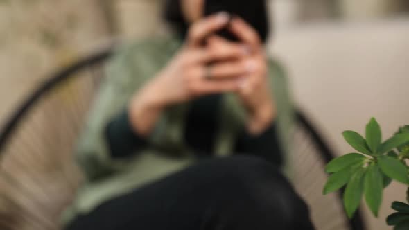 Woman using phone, browsing smartphone apps, looking at screen