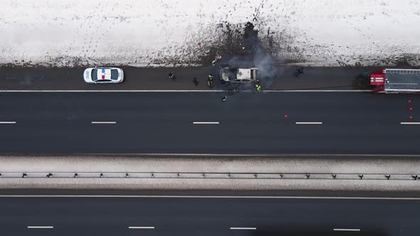 Accident  Burned Out Car on the Edge of the Motorway in Winter Aerial View