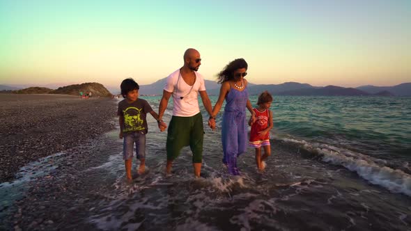 Family Walks On The Beach