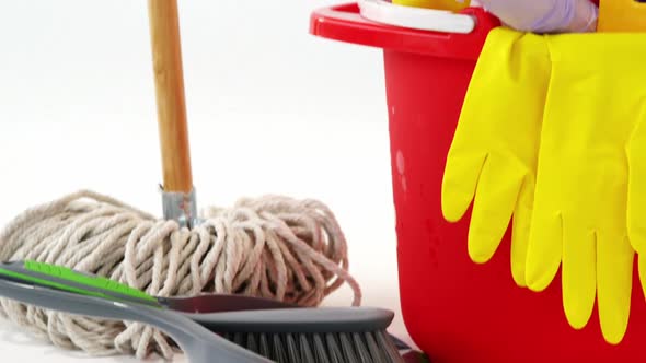 Various housekeeping supplies in a bucket