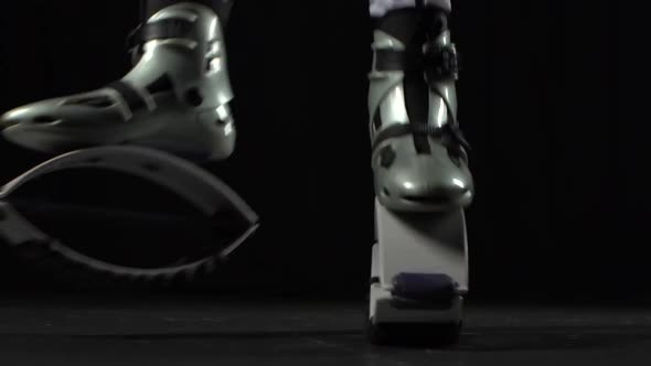 Close-up of Legs Doing Exercises in Kangoo Jumps. Slow Motion