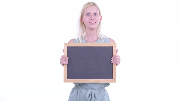 Happy Young Blonde Woman Holding Blackboard and Getting Good News