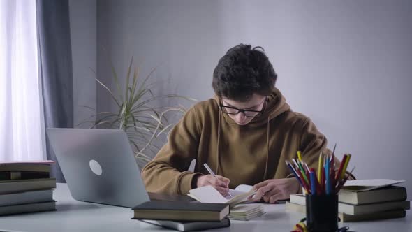 Calm Caucasian Boy Making Mistake in Notes and Throwing Teared Off Page To Camera. College Student