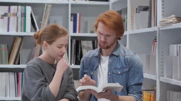 Serious Students Searching Information in Book in Library