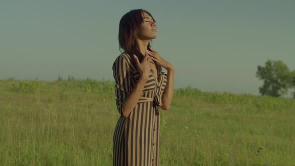 Portrait of Serene Lovely Black Female Inhaling Fresh Air in Summer Nature