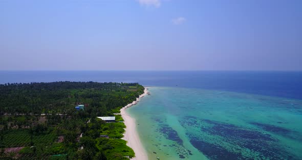 Wide aerial island view of a white sand paradise beach and aqua turquoise water background