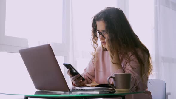 Lady Using Laptop at Glass Table in Sunshine