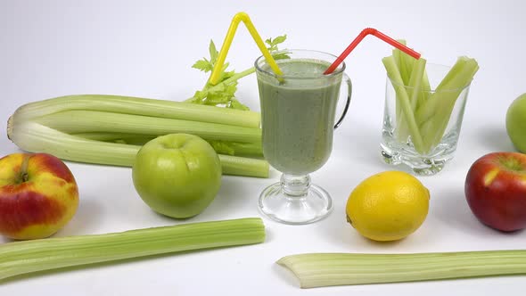 Glass mug with a straw filled with a smoothie is standing on the table