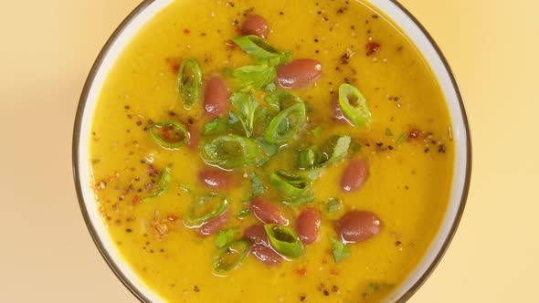 Sprinkling Spices on Bean Soup Closeup Rotating