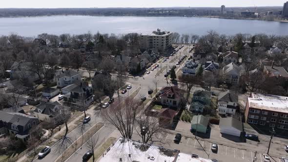 tilting up aerial drone shot of a suburban area and a lake