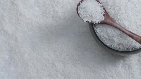 Raw Rice Grain In Bowl And Wooden Spoon Rotate, White Rice Grains Food Background