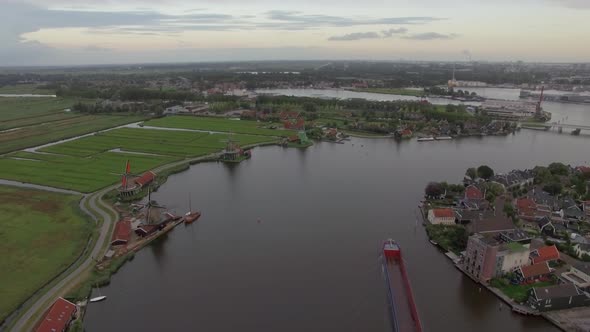 Aerial Shot of River with Windmills and Township, Netherlands