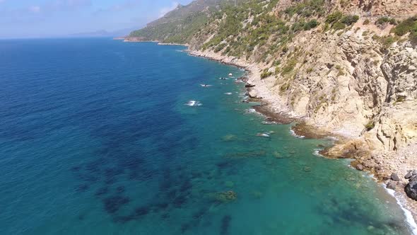 Aerial Clear Reef and Rocky Untouched Coastline of Bright Turquoise Sea